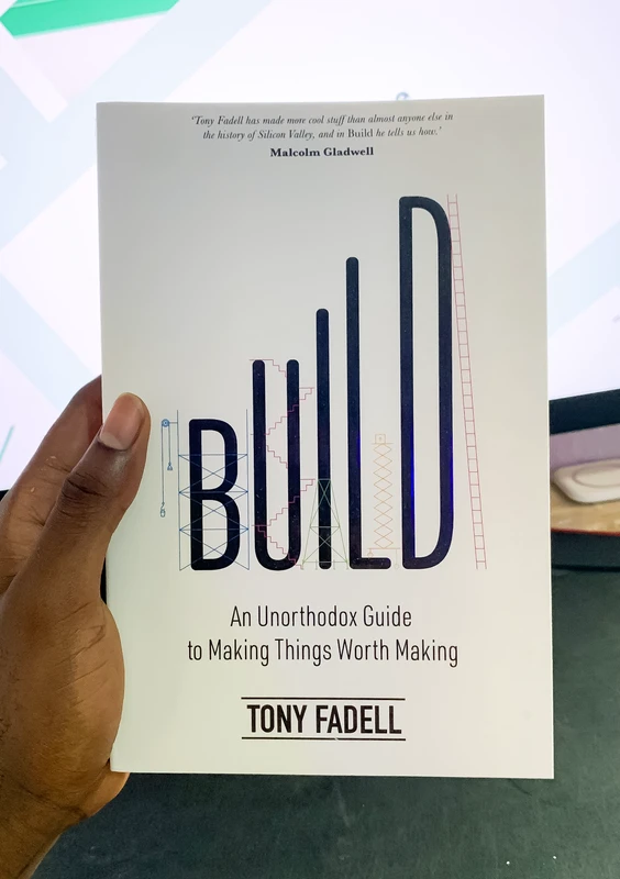 Bright holding the book Build by Tony Fadell