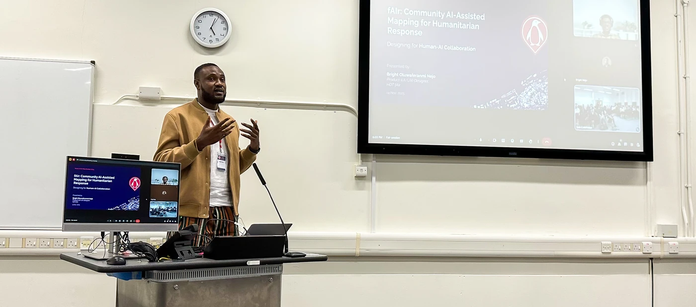 Bright presenting fAIr on stage at State of the Map Europe 2025